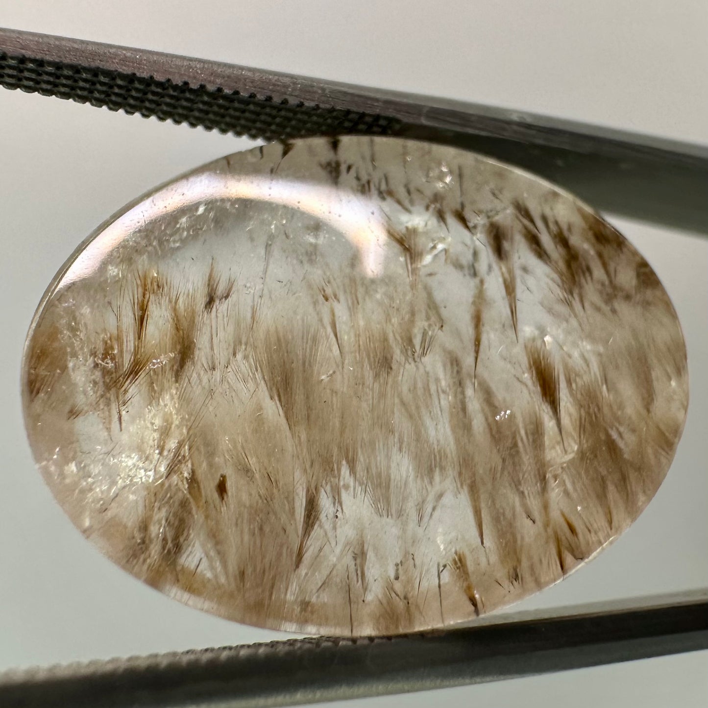 Cocoxenite in Quartz Oval Gem