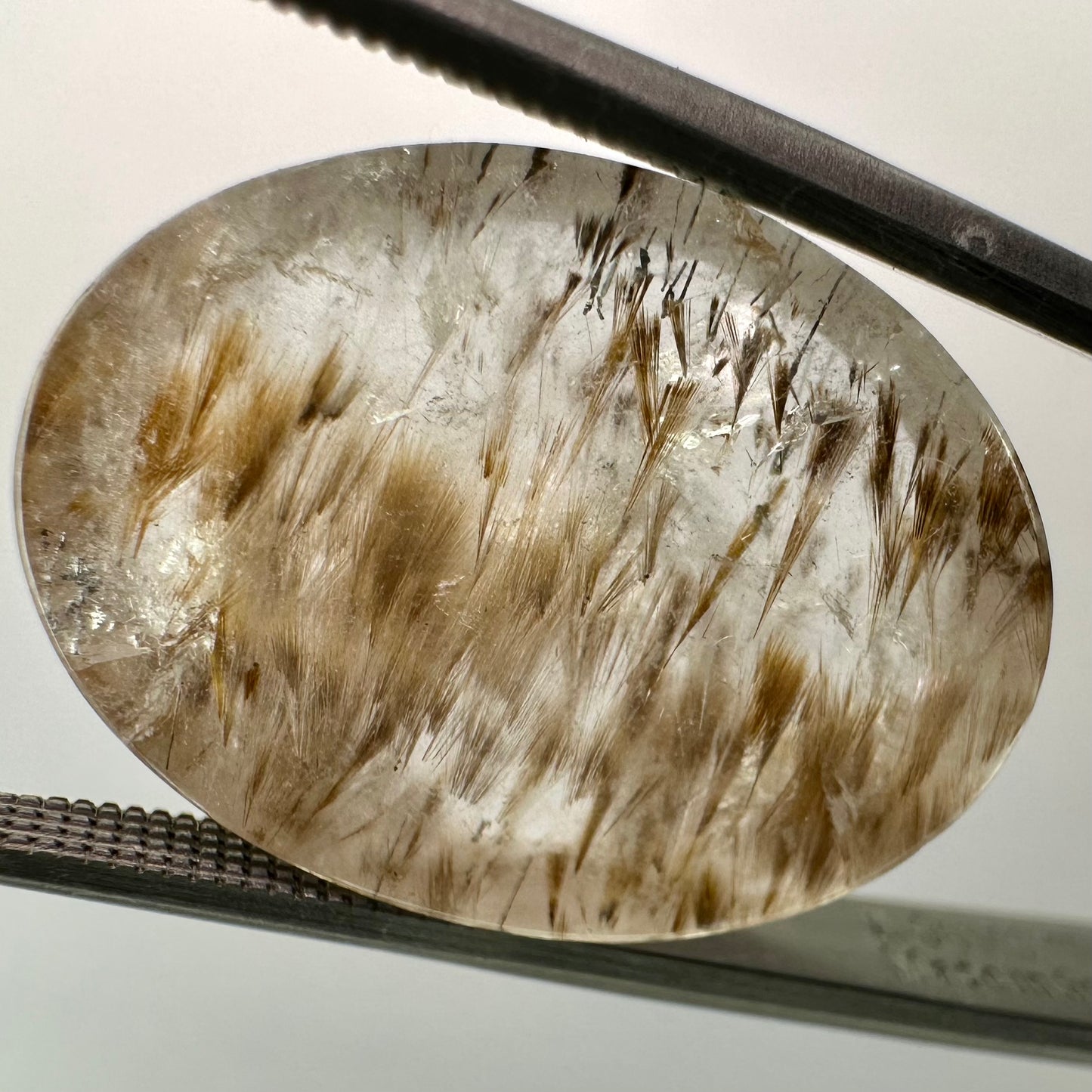 Cocoxenite in Quartz Oval Gem
