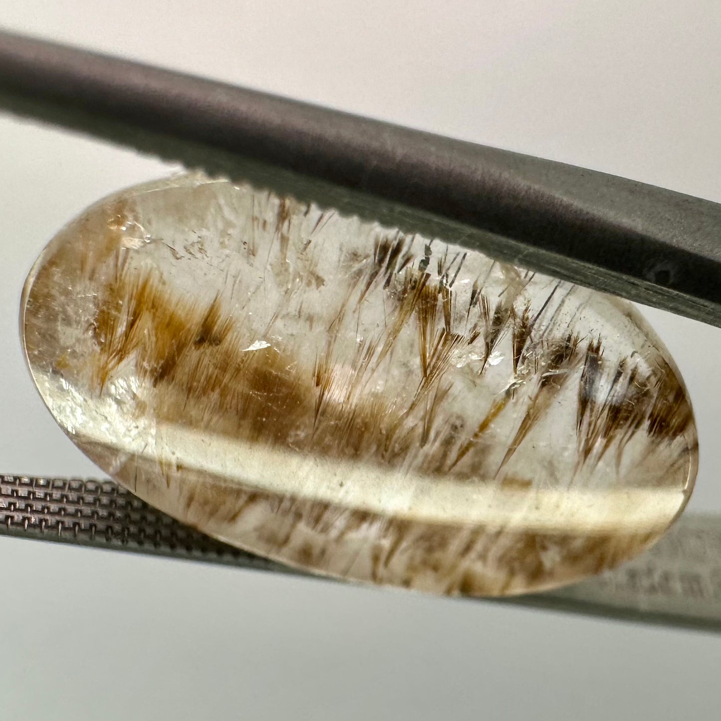 Cocoxenite in Quartz Oval Gem