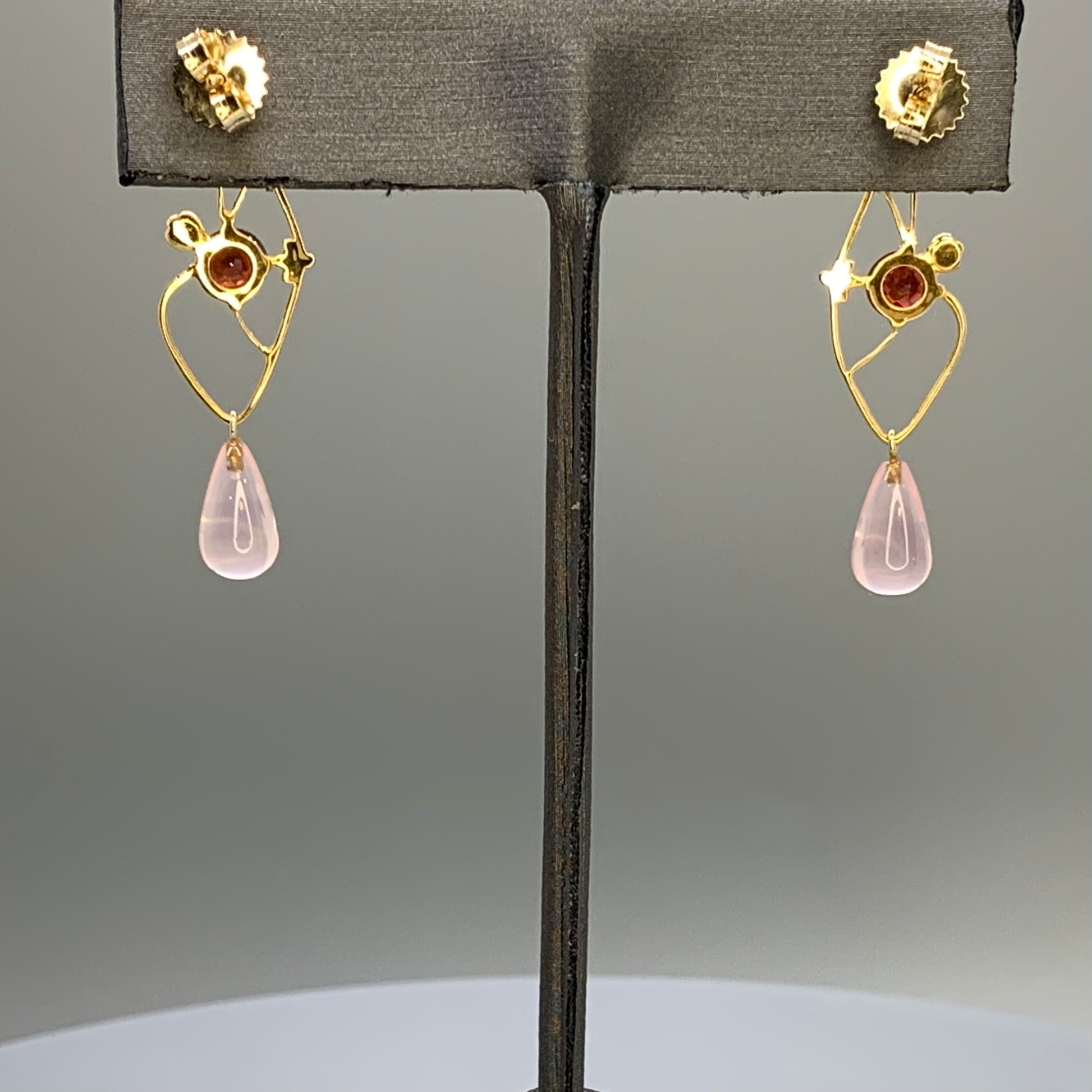 Back view of earrings, showing post and well fitting nut, along with open back for the garnet gemstones and wire work.